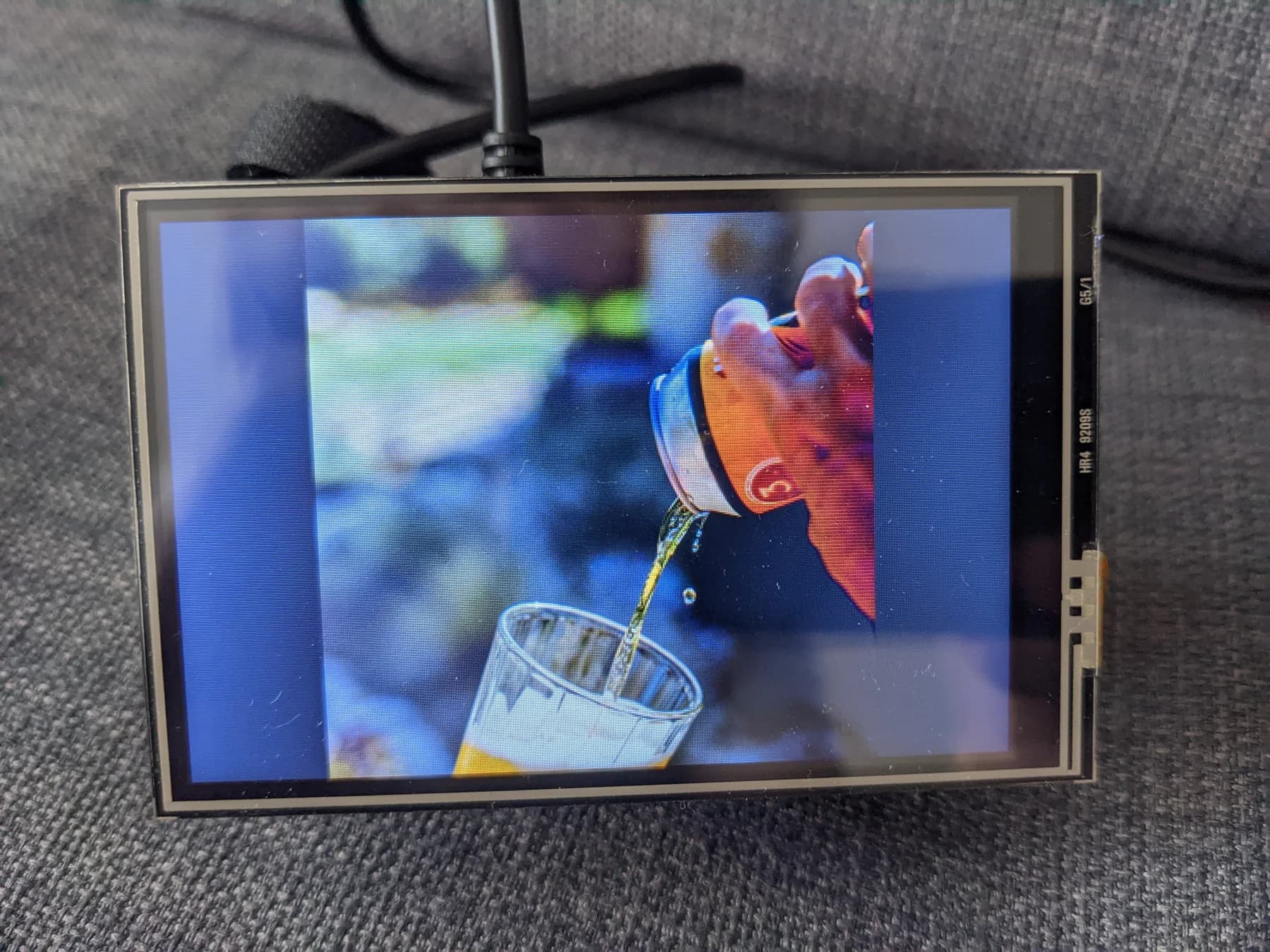 LCD prototype displaying a photograph of a drink being poured