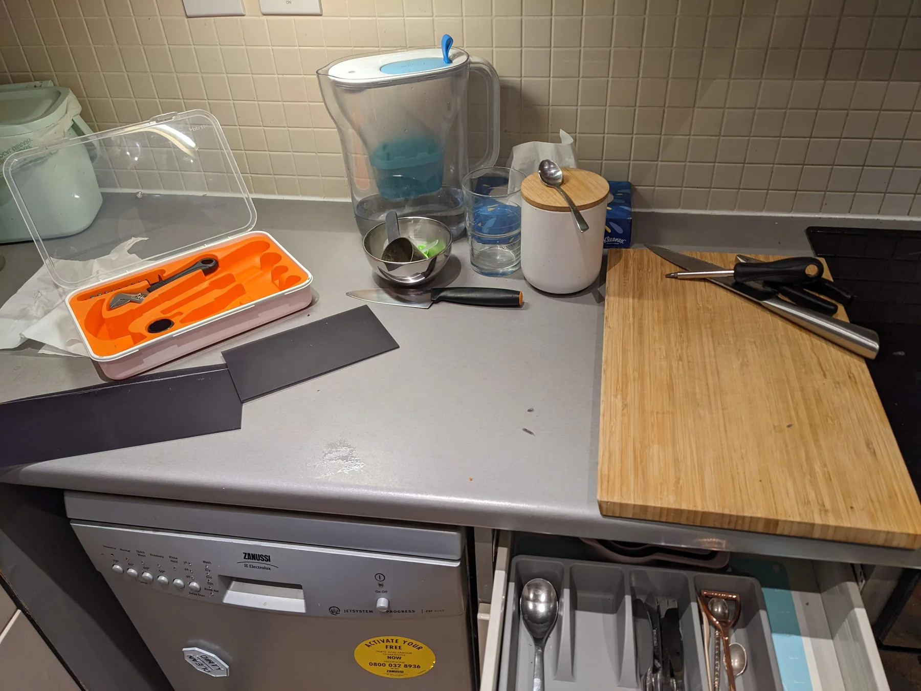 Work surface with cutting tools, backing material, and a wooden board