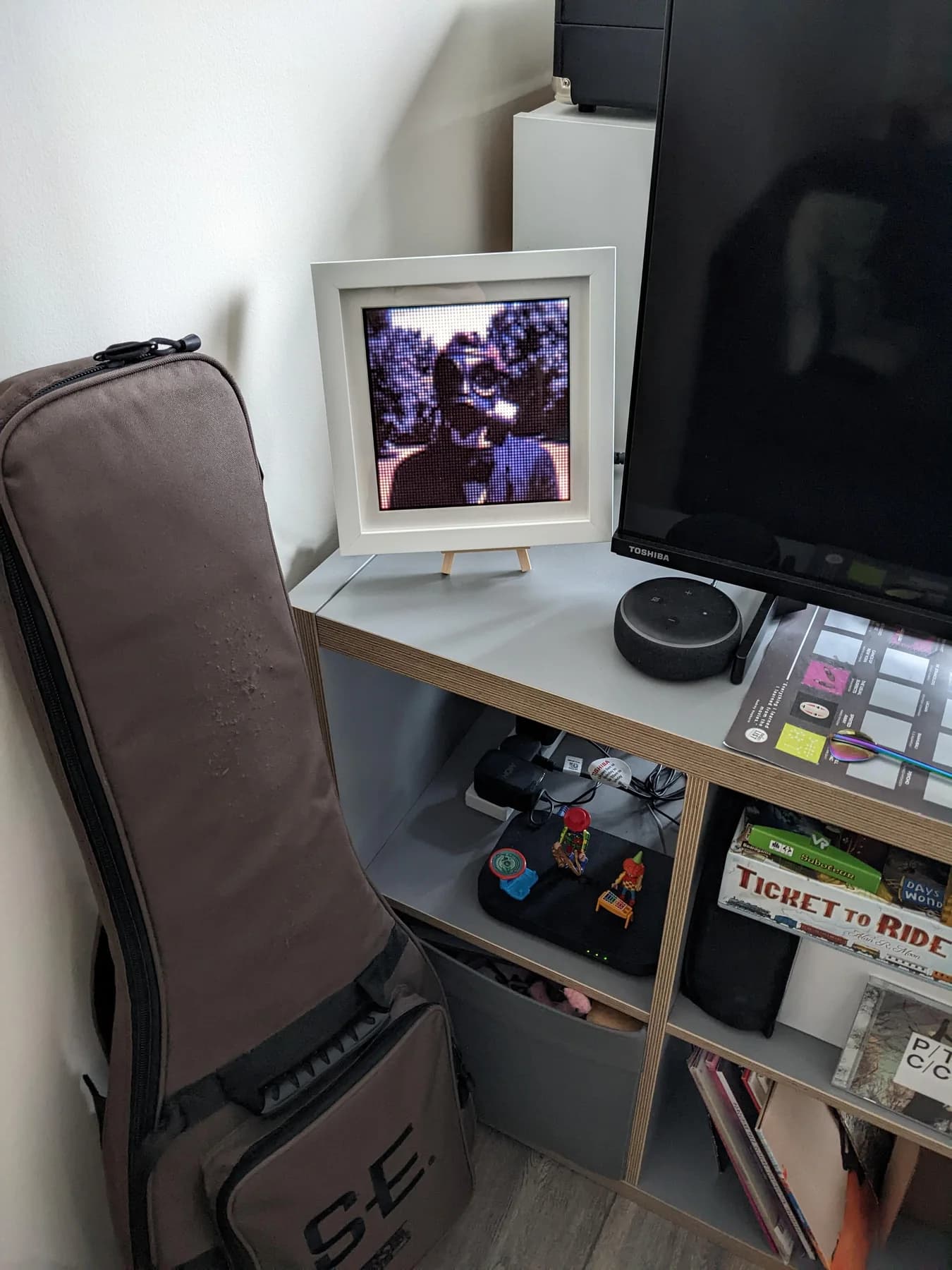 Wider view of the finished display on a shelf beside a television