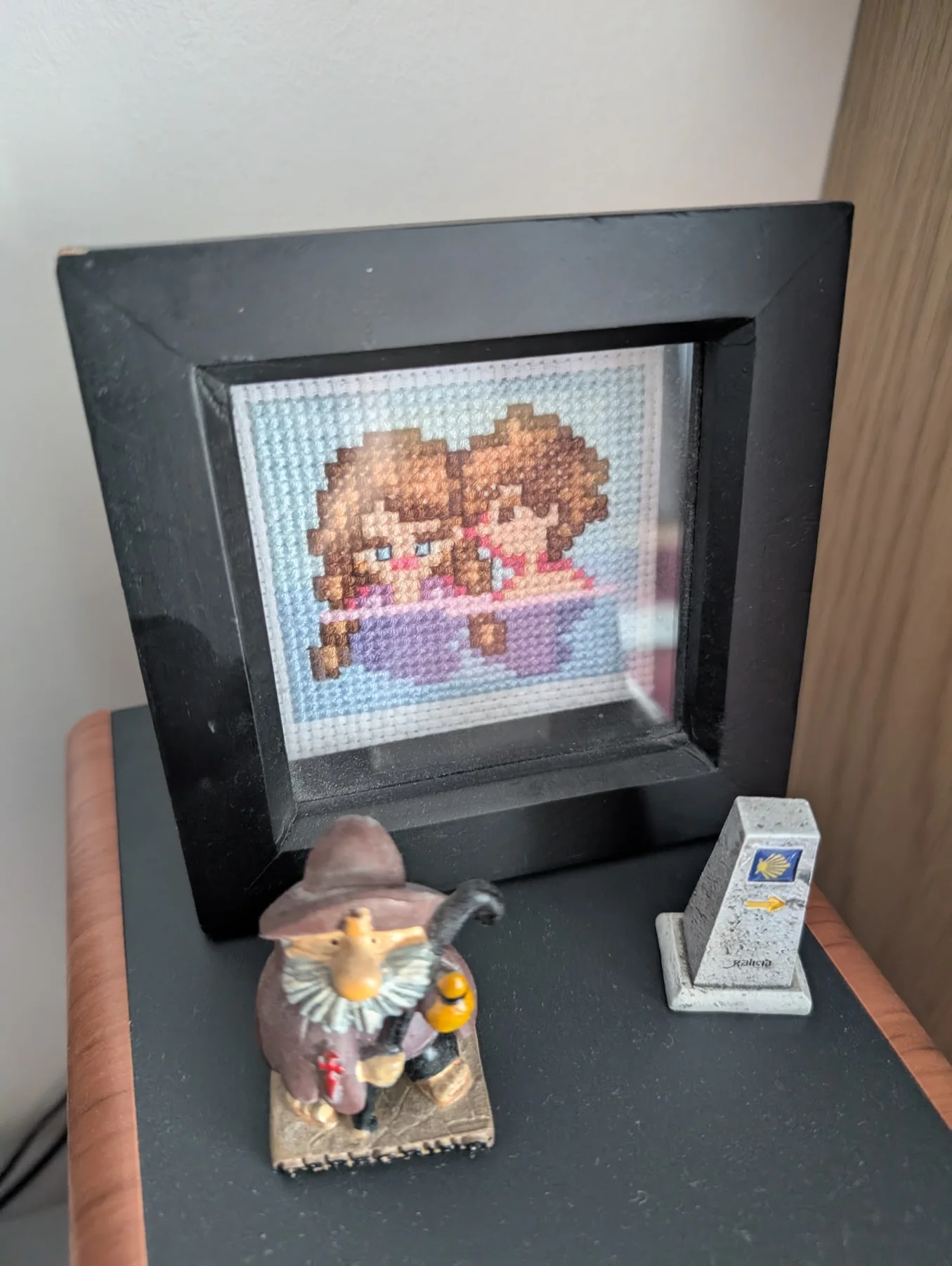 Kami’s Stardew Valley cross-stitch of our characters, framed in black